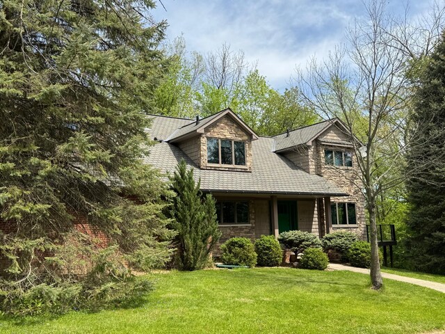 5557 N Territorial Rd, Ann Arbor, MI 48105 - shingle-style home with a front yard and stone siding