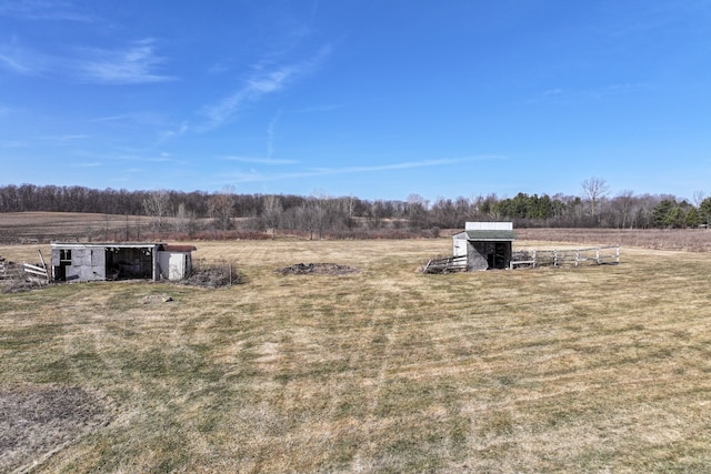 view of yard with an outbuilding and a rural view