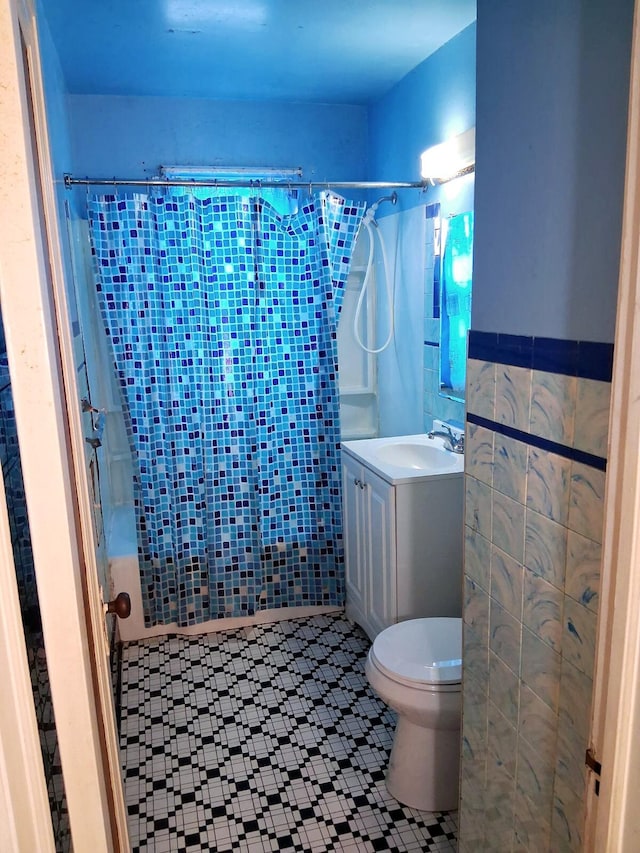 19328 Dresden St, Detroit, MI 48205 - bathroom featuring vanity, tile patterned floors, toilet, and shower / bath combo with shower curtain