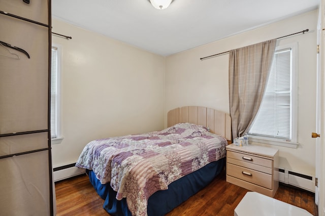 bedroom featuring dark wood-style floors and baseboard heating