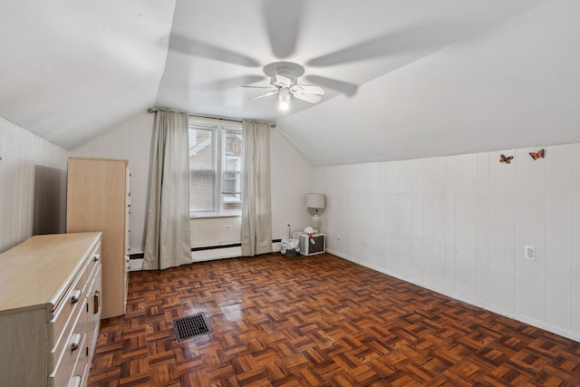 additional living space with lofted ceiling, a ceiling fan, and a baseboard radiator