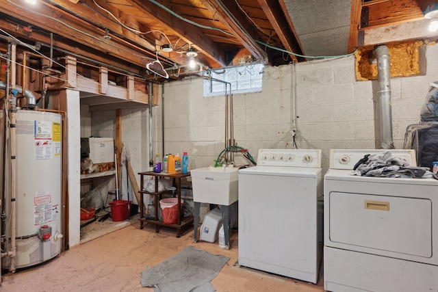 clothes washing area with independent washer and dryer, laundry area, and water heater