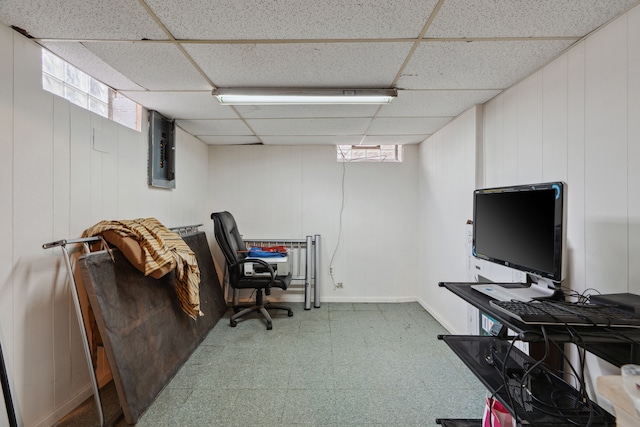 office space featuring tile patterned floors, electric panel, and a paneled ceiling