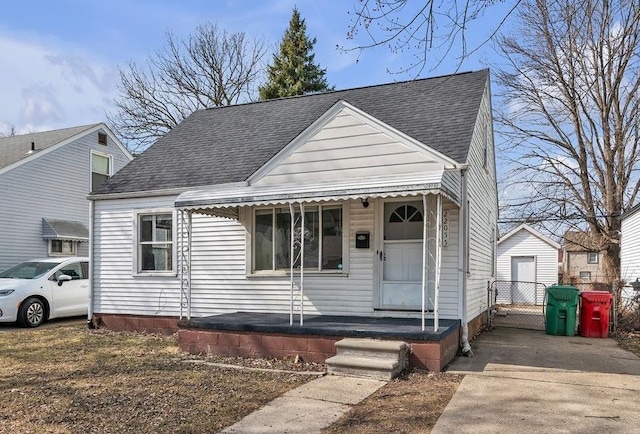 bungalow-style home with a shingled roof