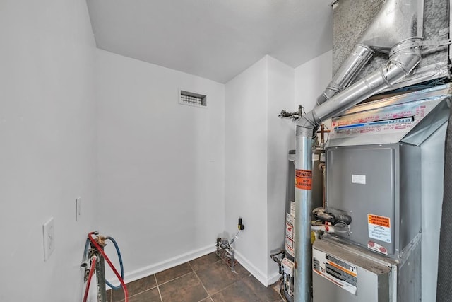 utility room featuring visible vents and gas water heater