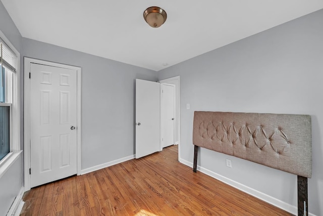 unfurnished bedroom featuring baseboards and wood finished floors