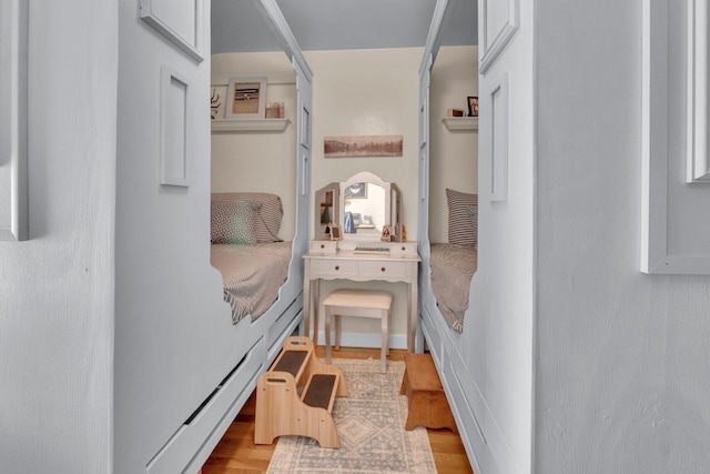 bedroom with light wood-style flooring and a baseboard radiator