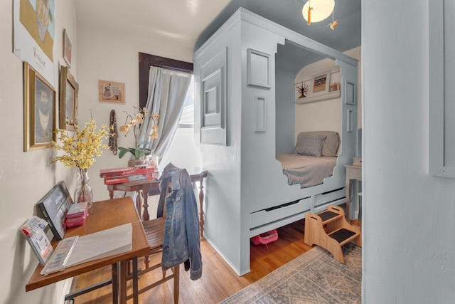 interior space featuring light wood-type flooring and baseboards