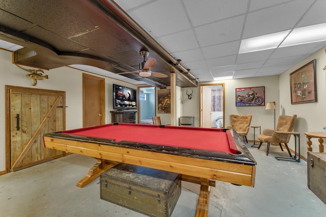 recreation room with billiards, a paneled ceiling, and concrete floors