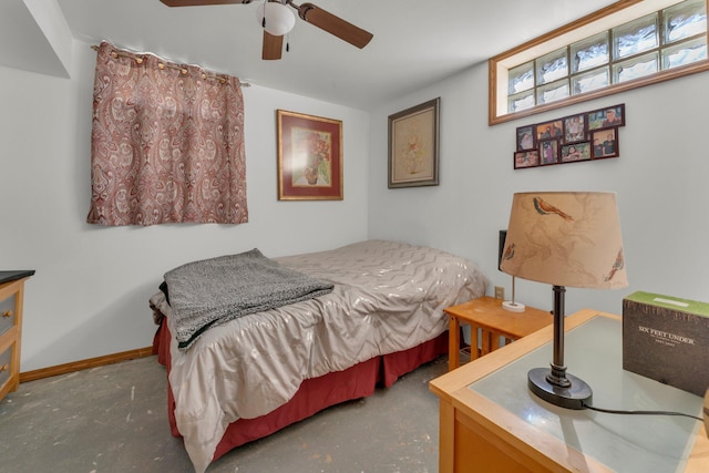 bedroom featuring a ceiling fan, baseboards, and concrete floors