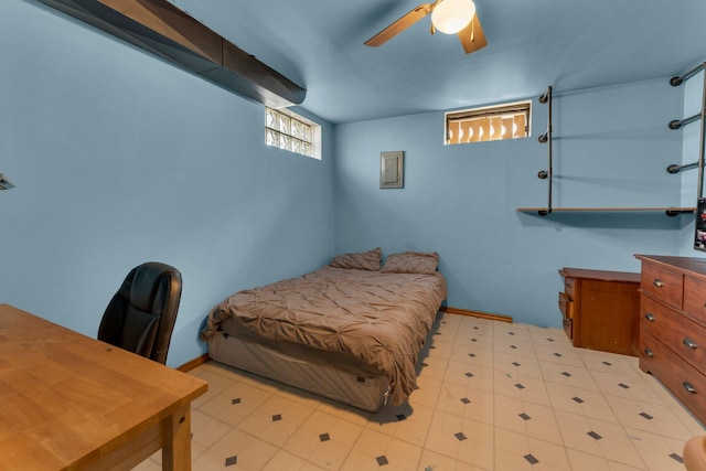 bedroom with tile patterned floors, baseboards, electric panel, and ceiling fan