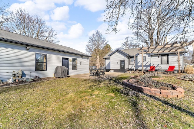 rear view of property with a yard and a patio area