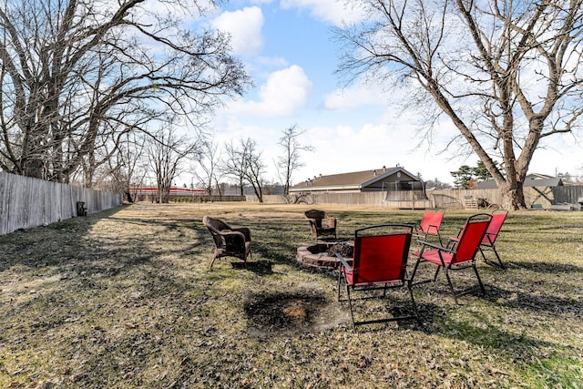 view of yard with a fire pit and a fenced backyard