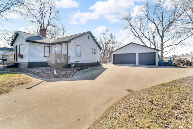 view of home's exterior with a garage, roof with shingles, an outdoor structure, and a chimney