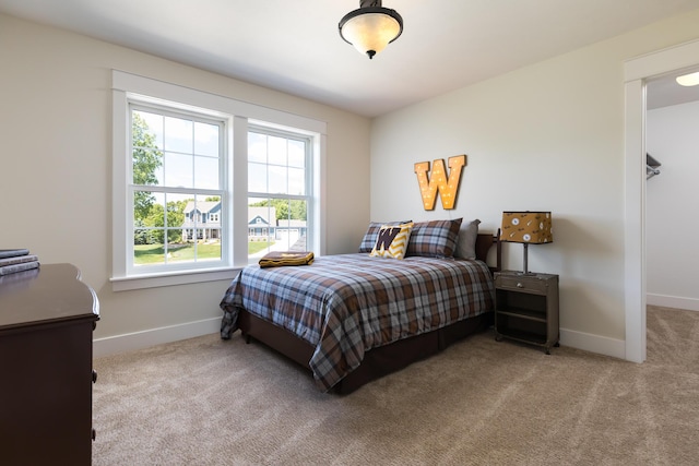 bedroom featuring carpet flooring and baseboards