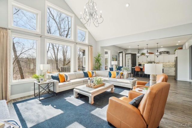 living room with wood finished floors, baseboards, high vaulted ceiling, recessed lighting, and a chandelier