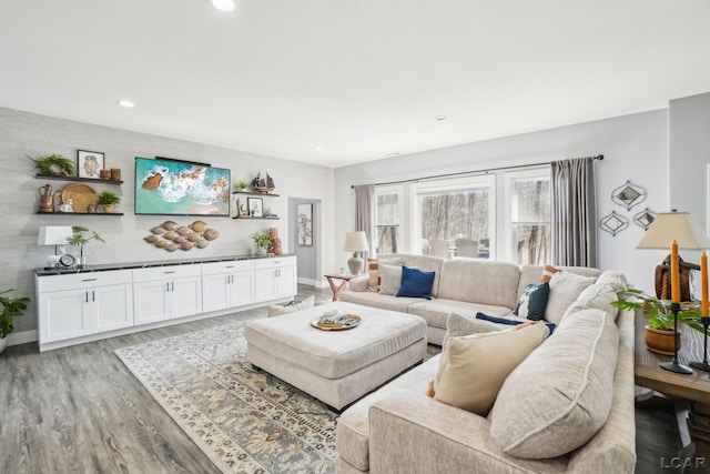 living room with recessed lighting, baseboards, and light wood finished floors