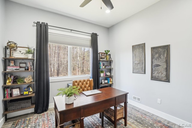 office area with visible vents, baseboards, a ceiling fan, and wood finished floors