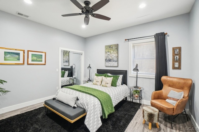 bedroom with visible vents, baseboards, recessed lighting, wood finished floors, and a ceiling fan