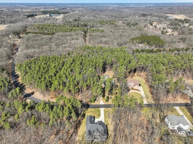 drone / aerial view with a wooded view