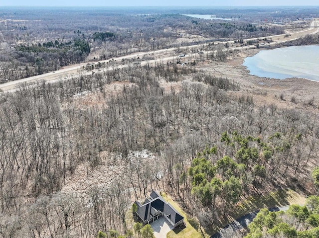 drone / aerial view with a water view and a wooded view