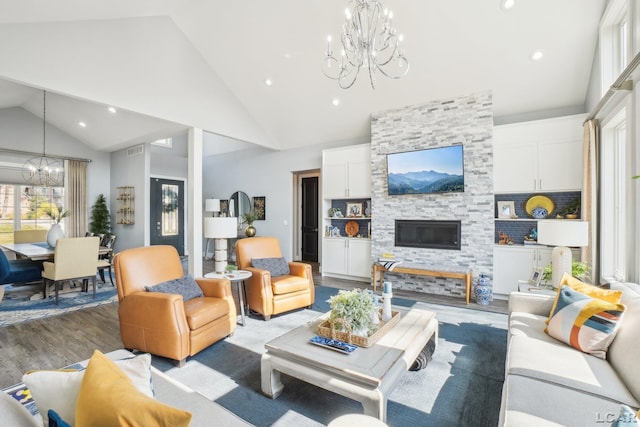 living area featuring a chandelier, recessed lighting, light wood-style flooring, a fireplace, and high vaulted ceiling