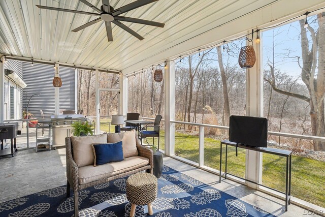 sunroom with a wealth of natural light and a ceiling fan