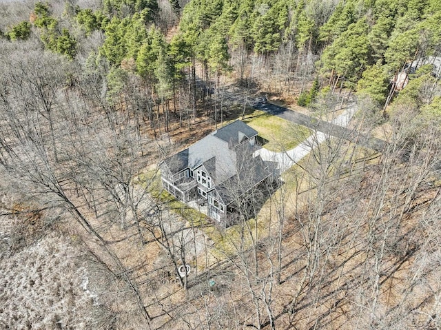 birds eye view of property featuring a view of trees