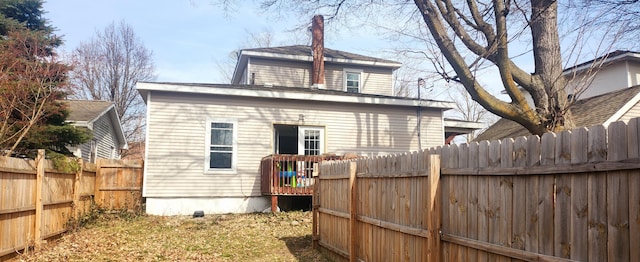 back of house with a fenced backyard