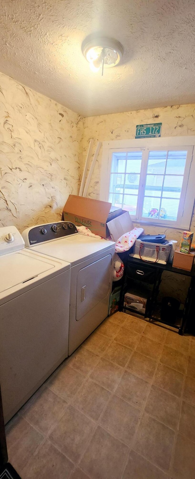 washroom with wallpapered walls, laundry area, plenty of natural light, and separate washer and dryer
