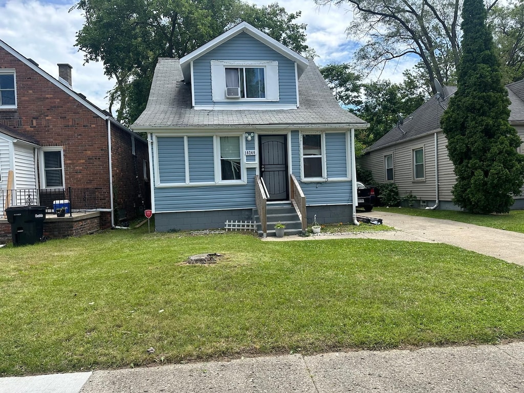 bungalow-style house featuring a front yard