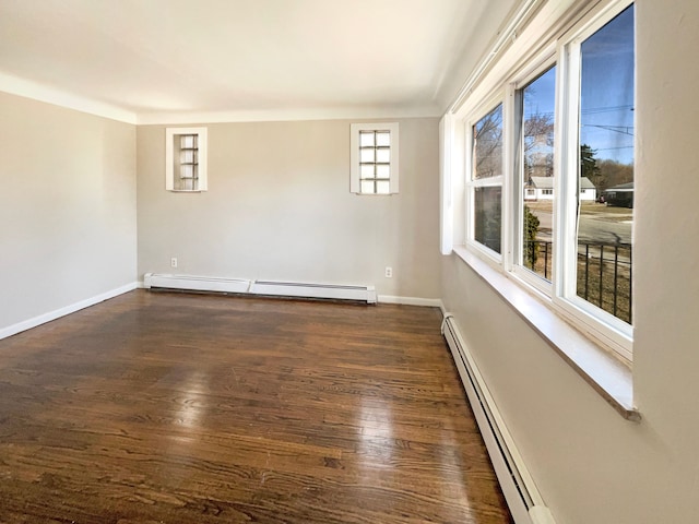 empty room with dark wood-style floors, baseboard heating, baseboards, and a baseboard radiator