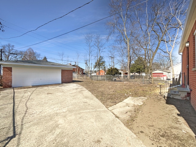 view of yard with entry steps, an outbuilding, fence, and a garage