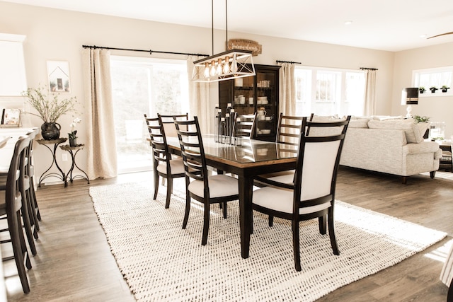 dining area featuring a chandelier and wood finished floors