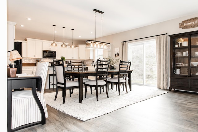 dining area with recessed lighting and wood finished floors