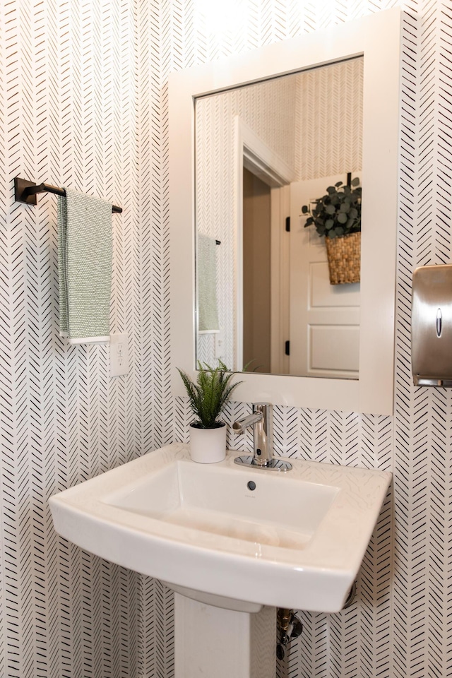 bathroom with a sink and tile walls