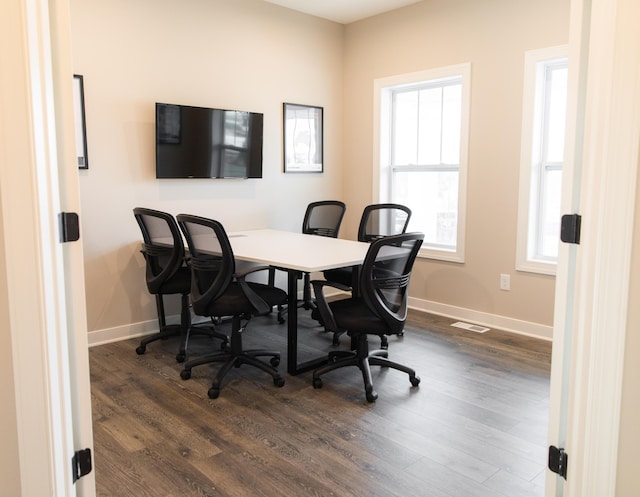 office space with visible vents, baseboards, and dark wood-style flooring