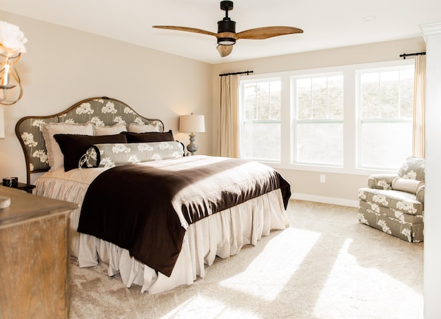 carpeted bedroom with baseboards and ceiling fan