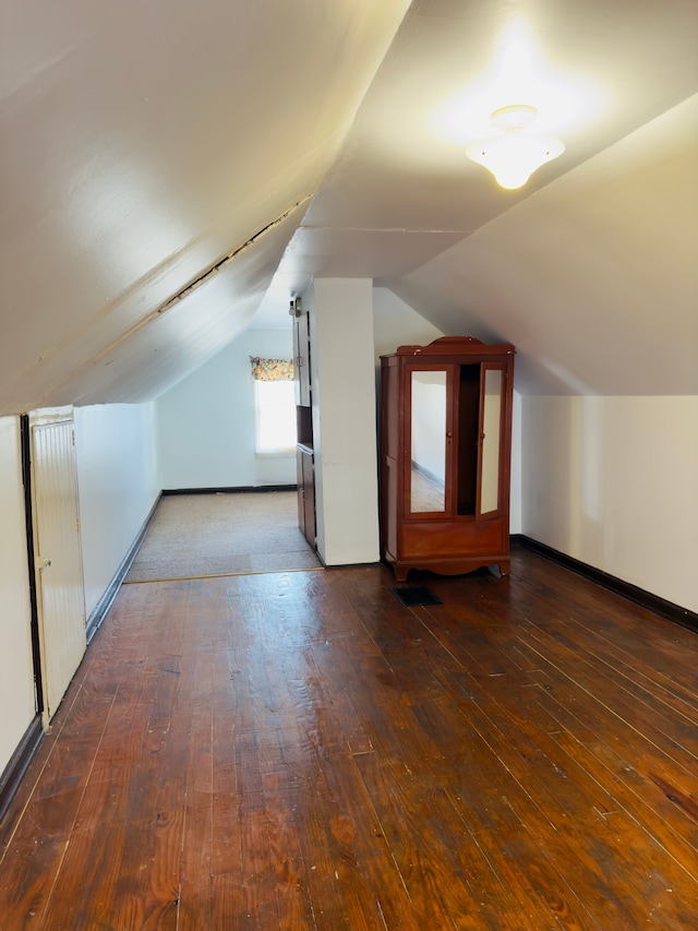 bonus room featuring vaulted ceiling, baseboards, and wood-type flooring