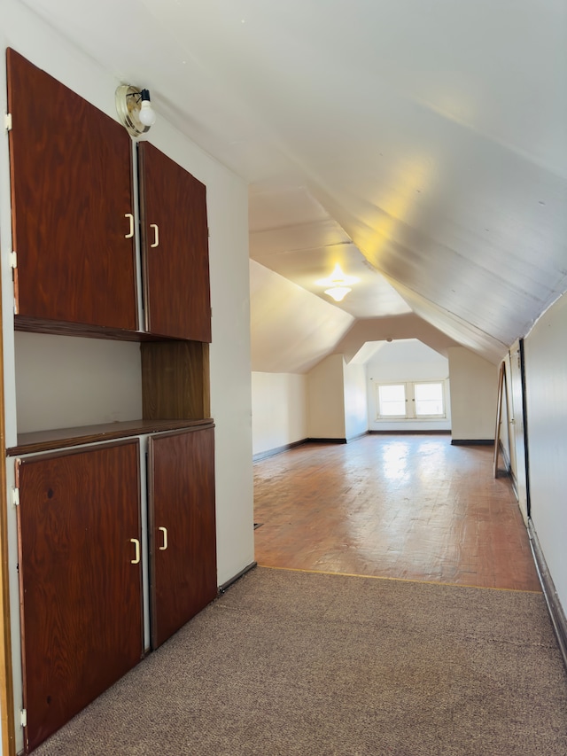 bonus room featuring light colored carpet and lofted ceiling