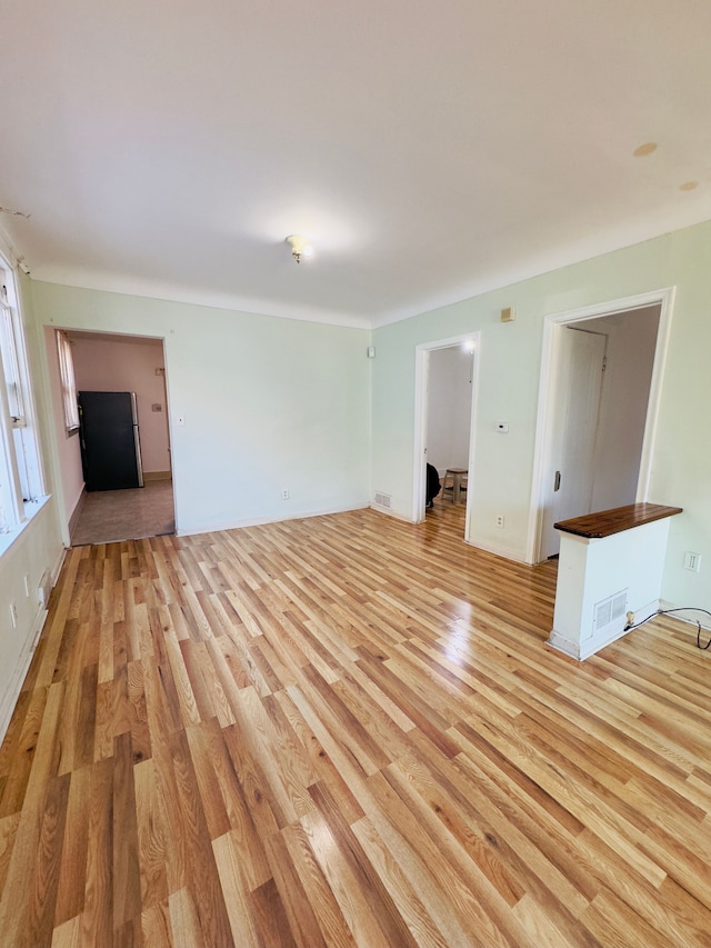 spare room with visible vents and light wood-type flooring