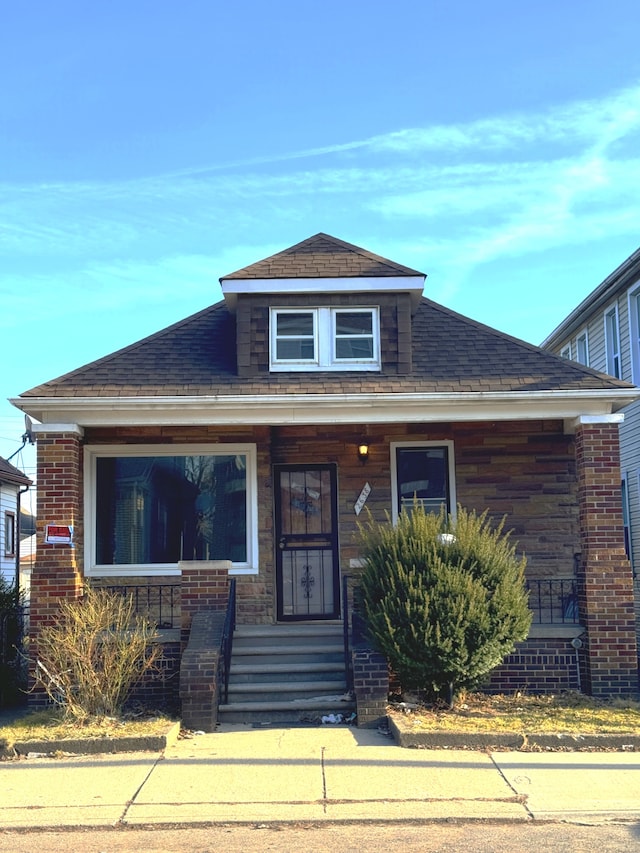 bungalow with a shingled roof