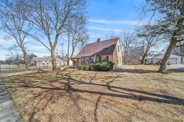 view of front of home with a front yard and a chimney