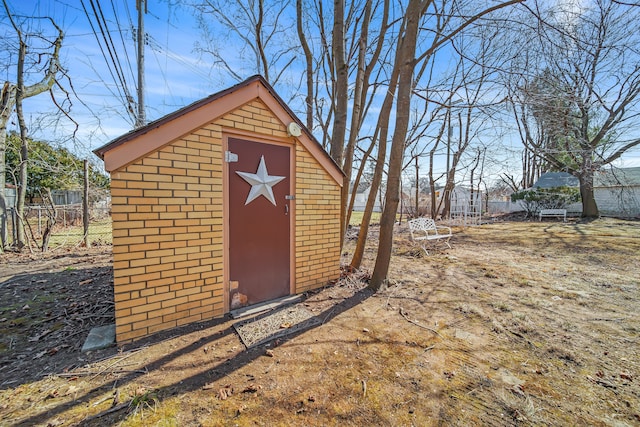 view of shed featuring fence