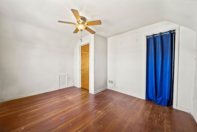 interior space featuring visible vents, a ceiling fan, hardwood / wood-style flooring, baseboards, and lofted ceiling