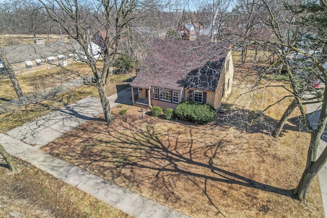 view of front of property featuring concrete driveway and a shingled roof