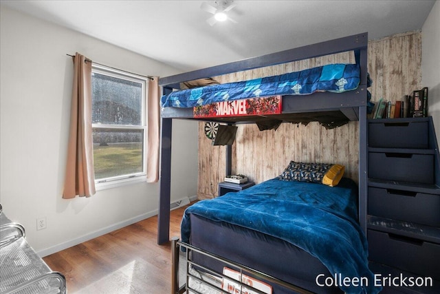 bedroom with visible vents, baseboards, and wood finished floors