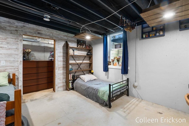 bedroom with unfinished concrete flooring