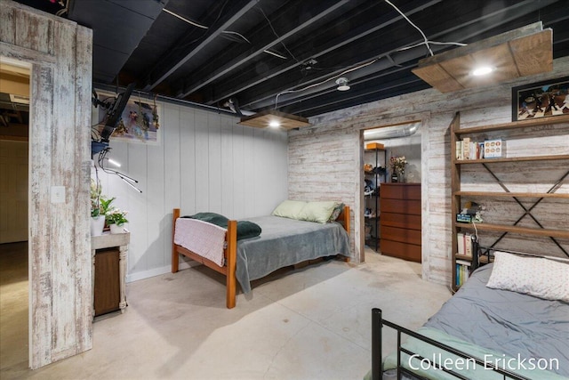 bedroom featuring concrete flooring