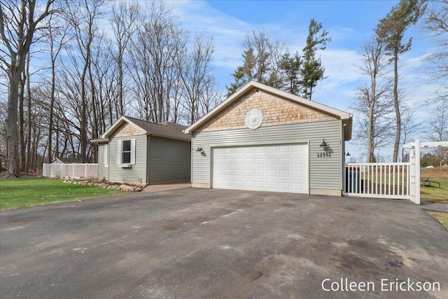 view of side of property with an outdoor structure and fence